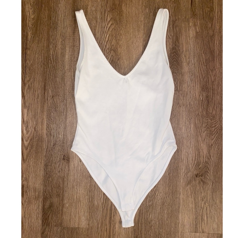 White v neck body suit.